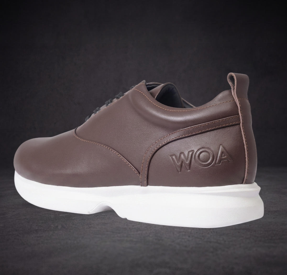WOA brown low-top sneaker heel and side view with logo patch and white sole