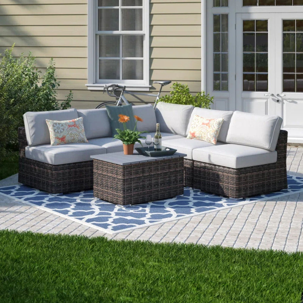Wicker sectional sofa with light gray cushions and matching square coffee table