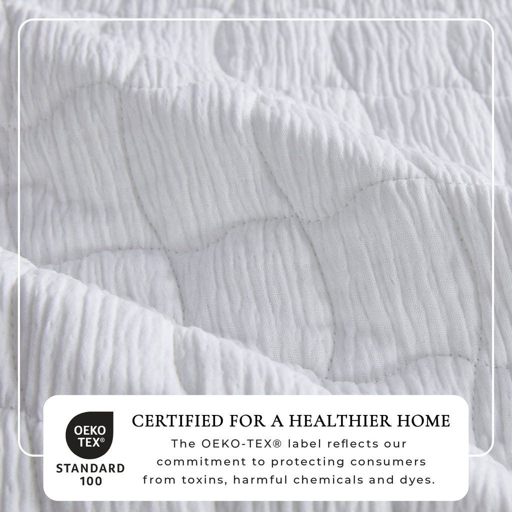 White gauze quilt set close-up, wave-stitch quilting with raised fabric texture