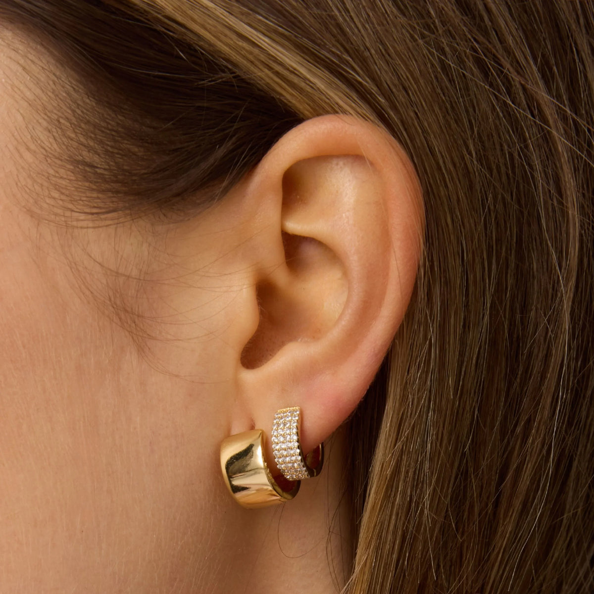 Gold hoop earrings with pavé crystal row