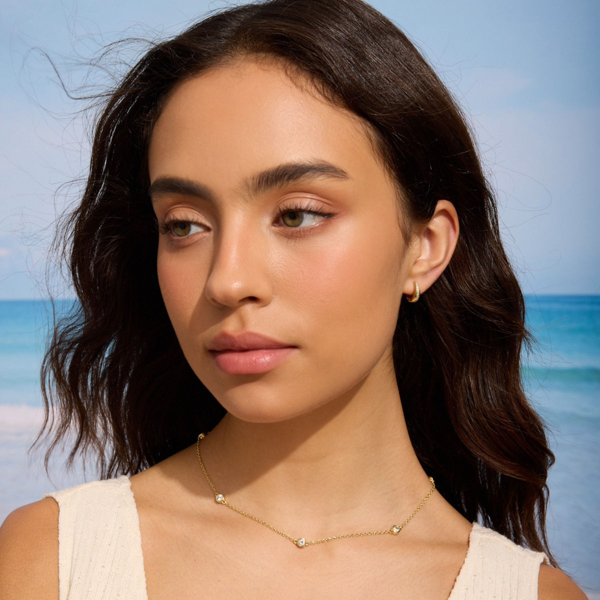 Gold filled necklace with five round diamond-like stones at the neckline