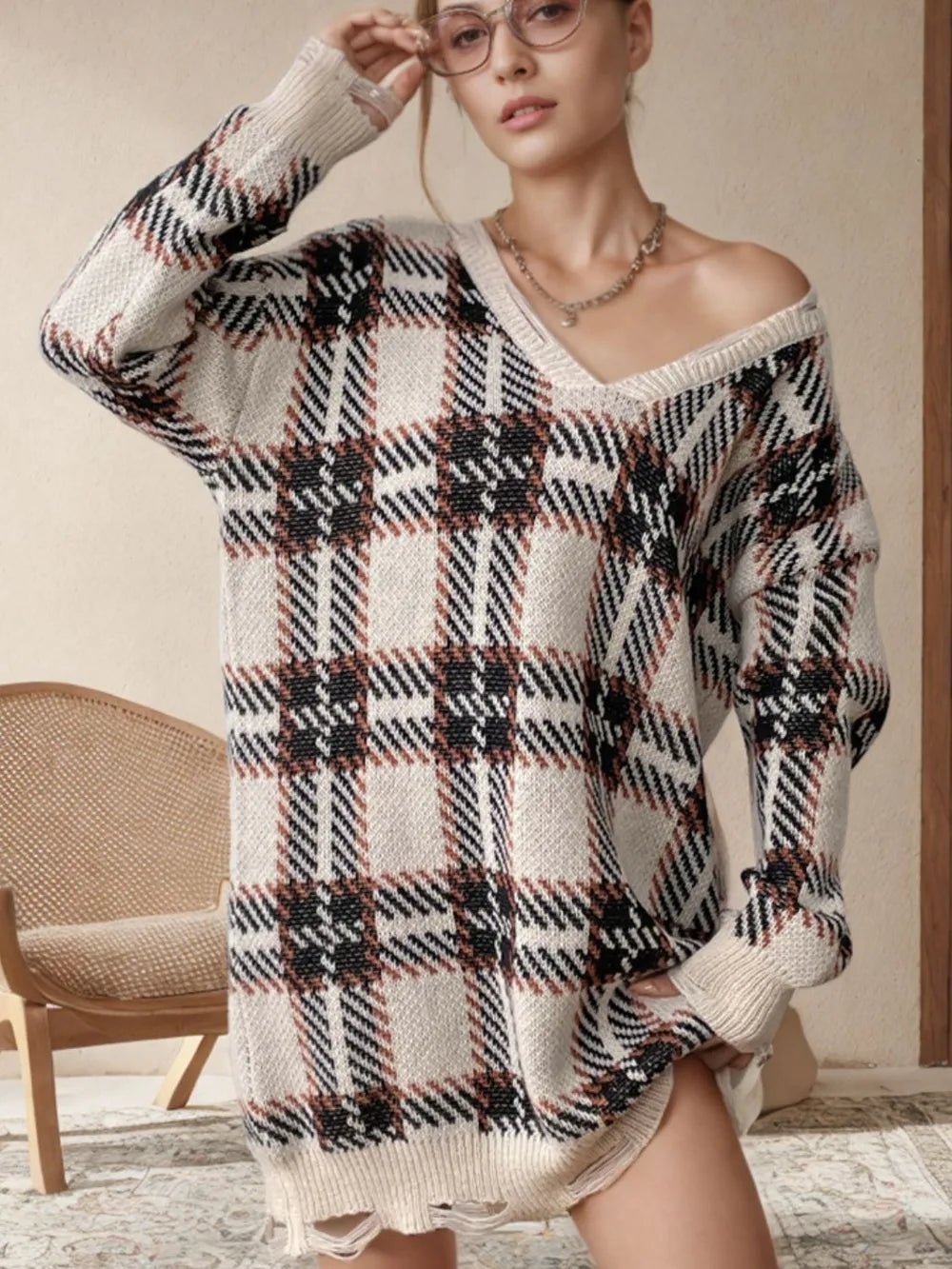 Distressed plaid sweater dress with V-neck and long sleeves, cream with black and red accents