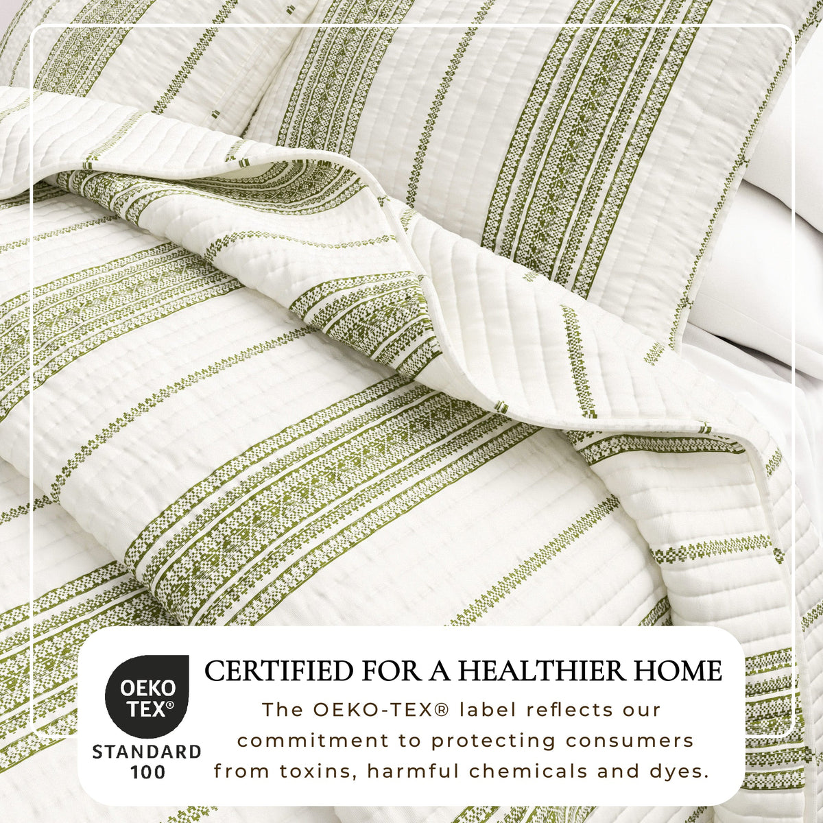 Striped quilt close-up with cream base and green vertical bands, quilted channels detail.