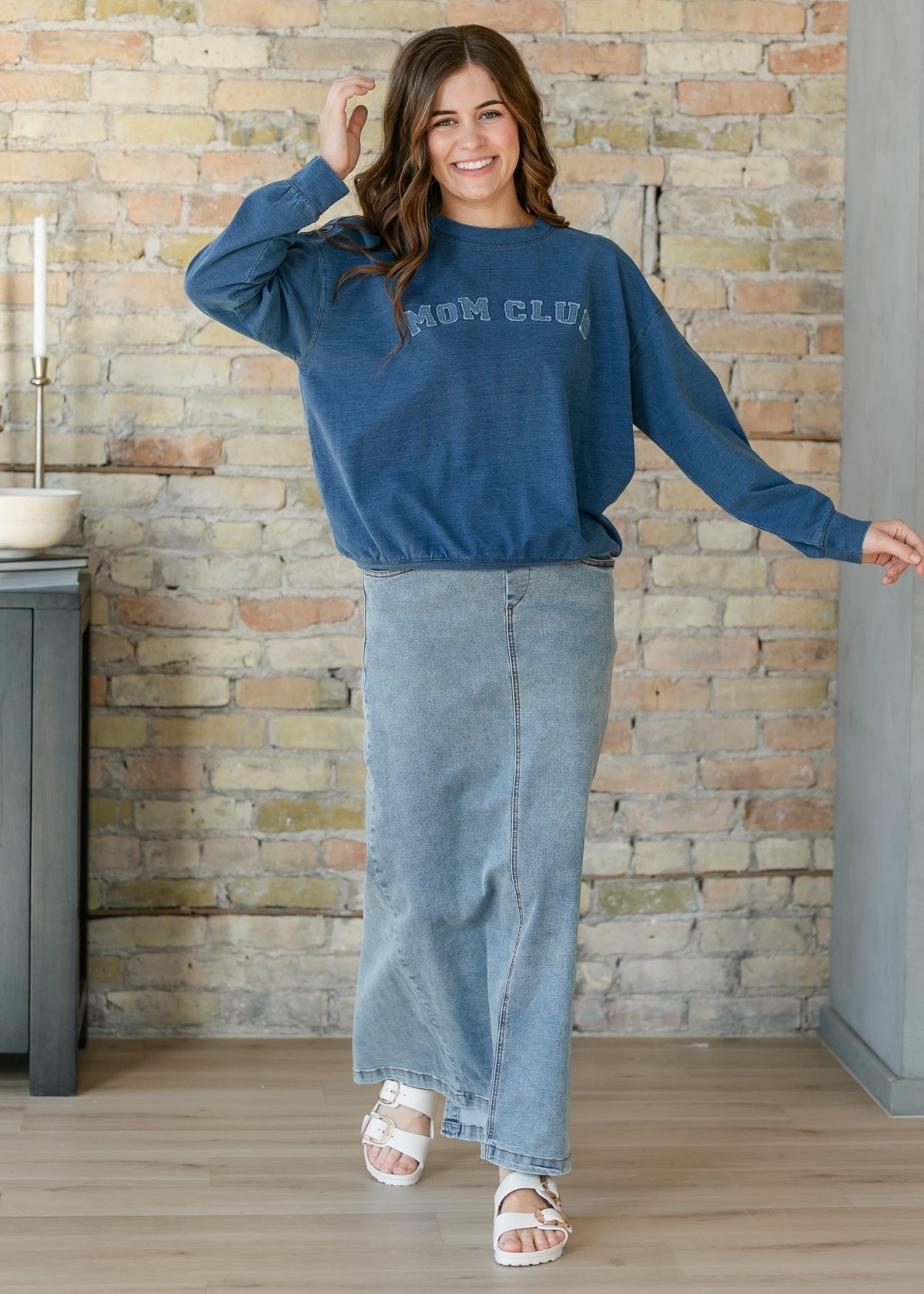 Light-wash maxi denim skirt with front seam and wide hem, full length