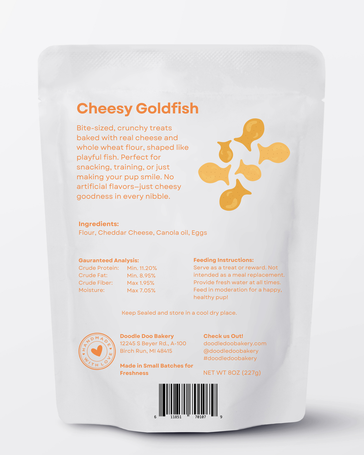 Cheesy goldfish dog treats pouch back with ingredients and feeding info.