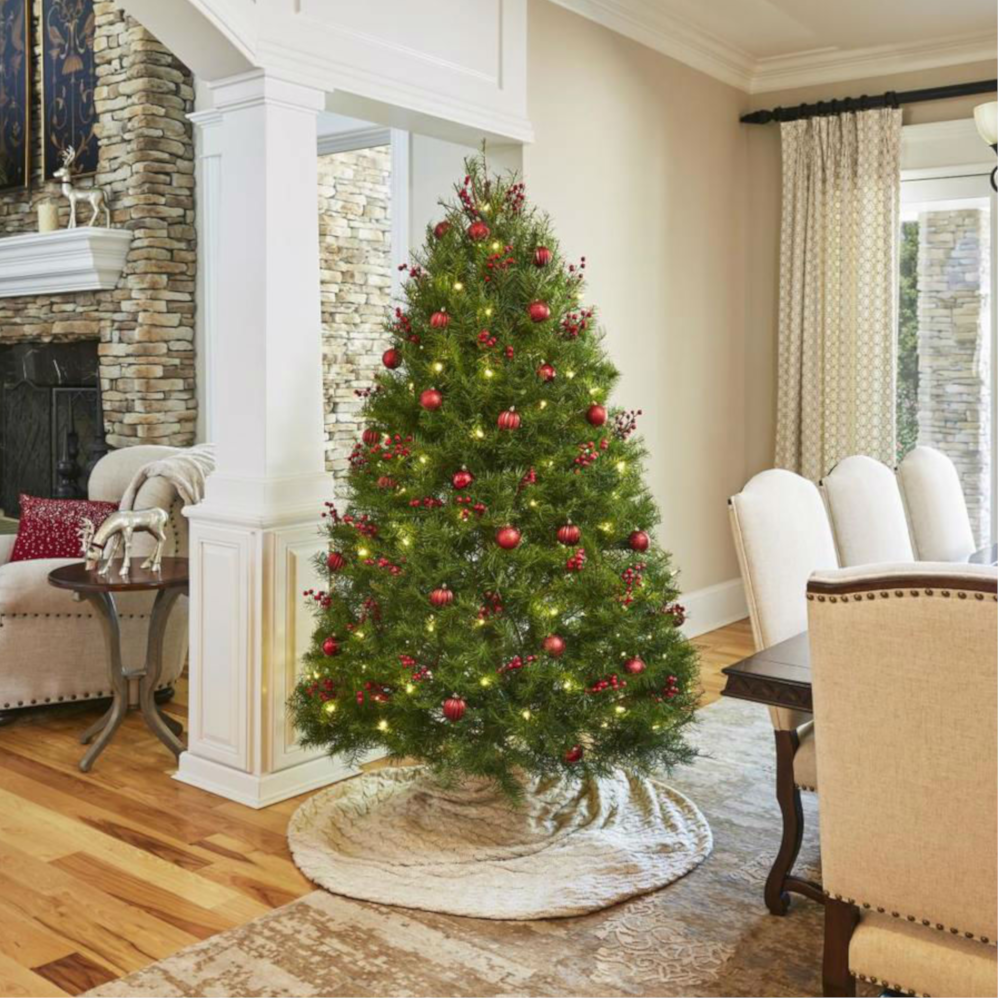 Decorated Douglas fir Christmas tree with red ornaments and lights indoors