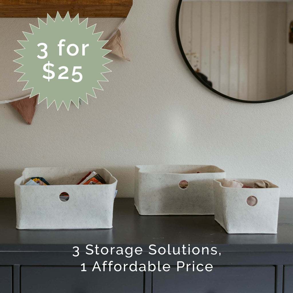 White felt storage bins with round handles, three organizer sizes on dresser