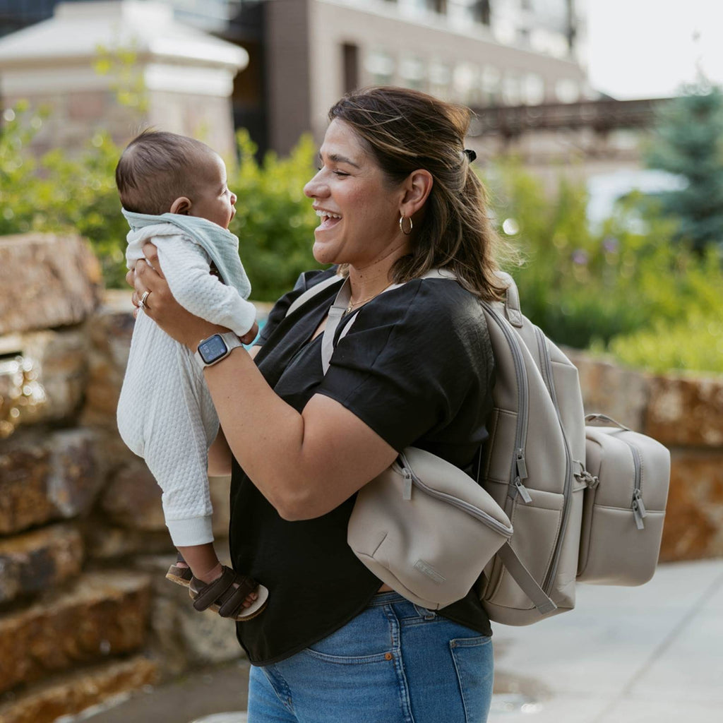 Neoprene diaper backpack in light gray with two zip pockets and side handle