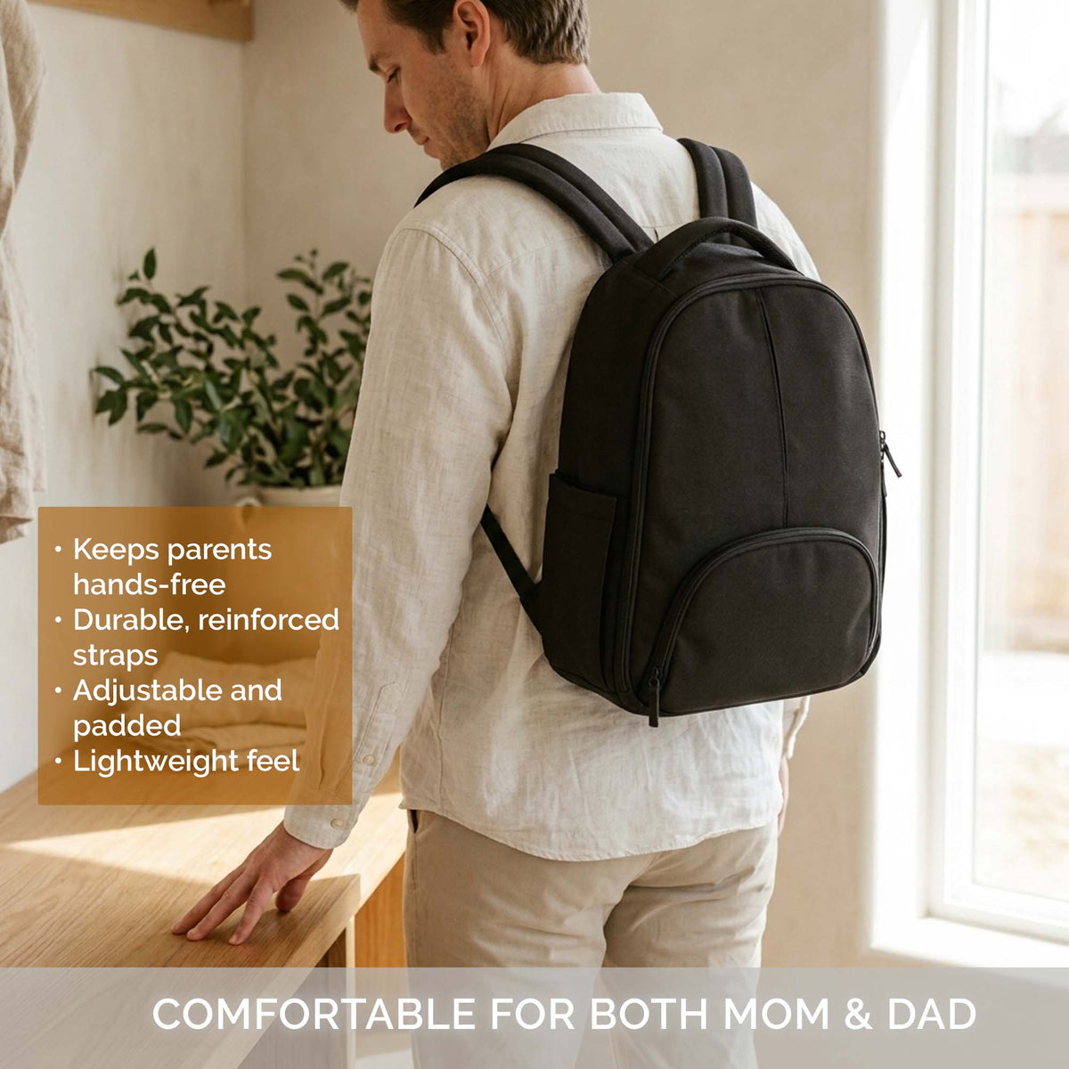 Black diaper backpack with adjustable padded straps, front pocket, and lightweight feet