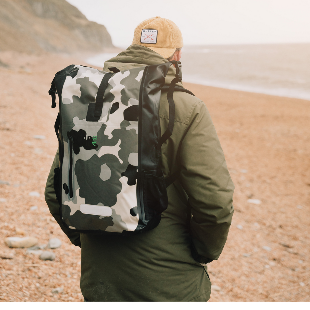 Camouflage waterproof dry bag backpack worn with roll-top closure and side carry straps