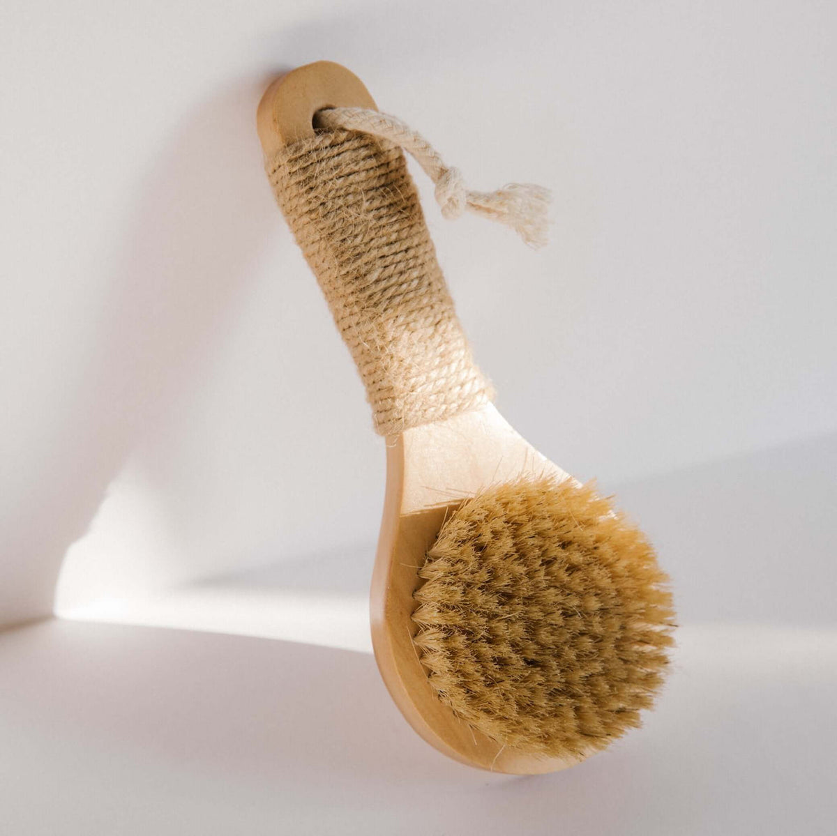 Round natural bristle dry brush with looped hemp twine handle