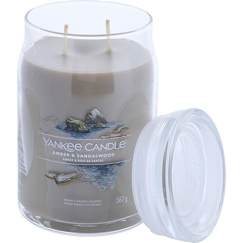 Large Yankee Candle jar with amber & sandalwood wax, two wicks, white glass lid