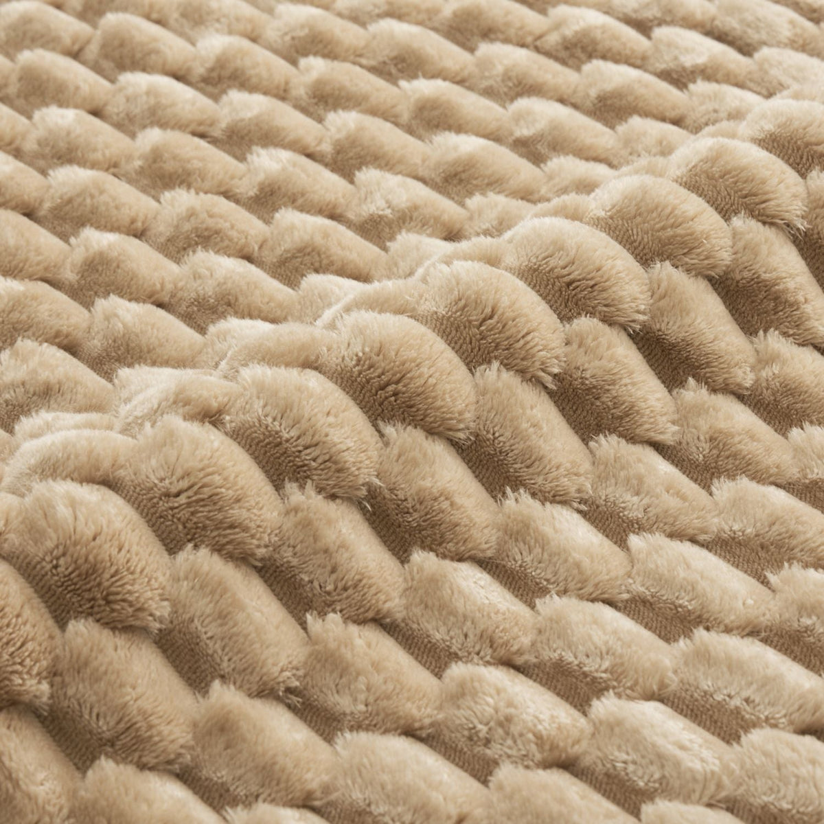 Close-up of light camel plush flannelette fabric with dense tufted loop texture