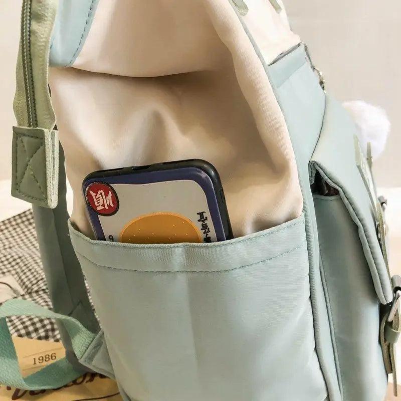 Light blue backpack with front organizer pocket and side key ring detail