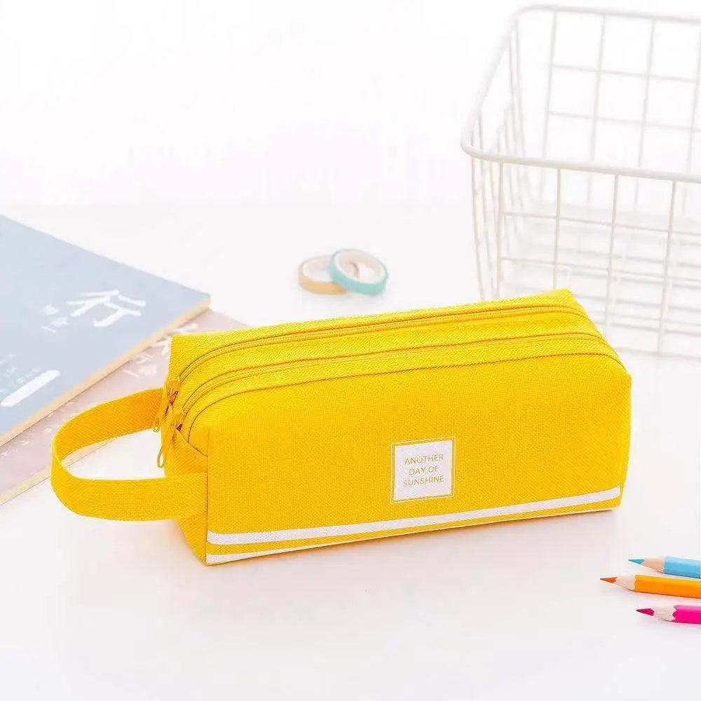 Yellow pencil case with wrist strap and rectangular front label