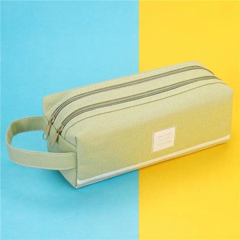 Light green double-layer pencil case with wrist strap, striped bands, and zip closure