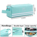 Light teal double-layer pencil case with wrist strap, striped bands, and zip closure