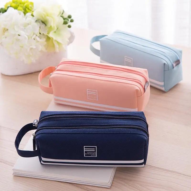 Set of double-layer pencil cases in navy and coral pink with top zip closures