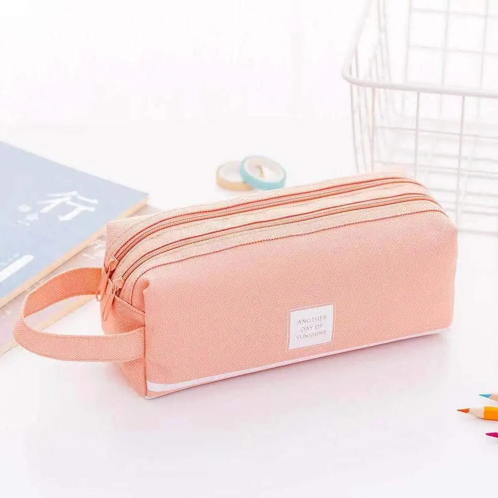 Peach double-layer pencil case with wrist strap, striped design, and zip closure