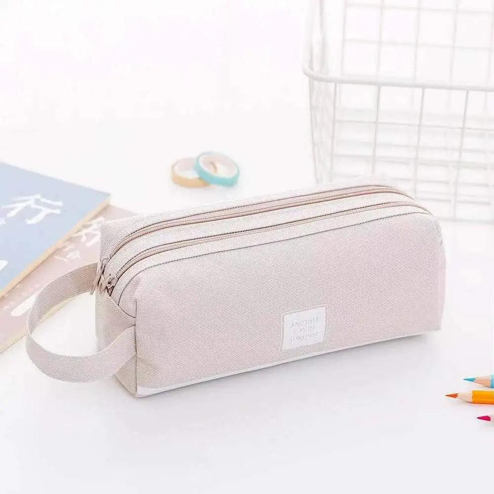 Double-layer pencil case in light pink with white stripe and carry handle