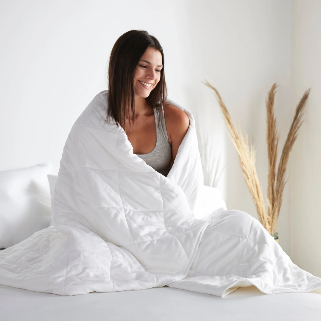 White duvet comforter covering a person, full baffle-quilted layers