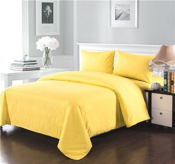 Banana yellow cotton duvet cover set on a bed with solid yellow pillows and duvet