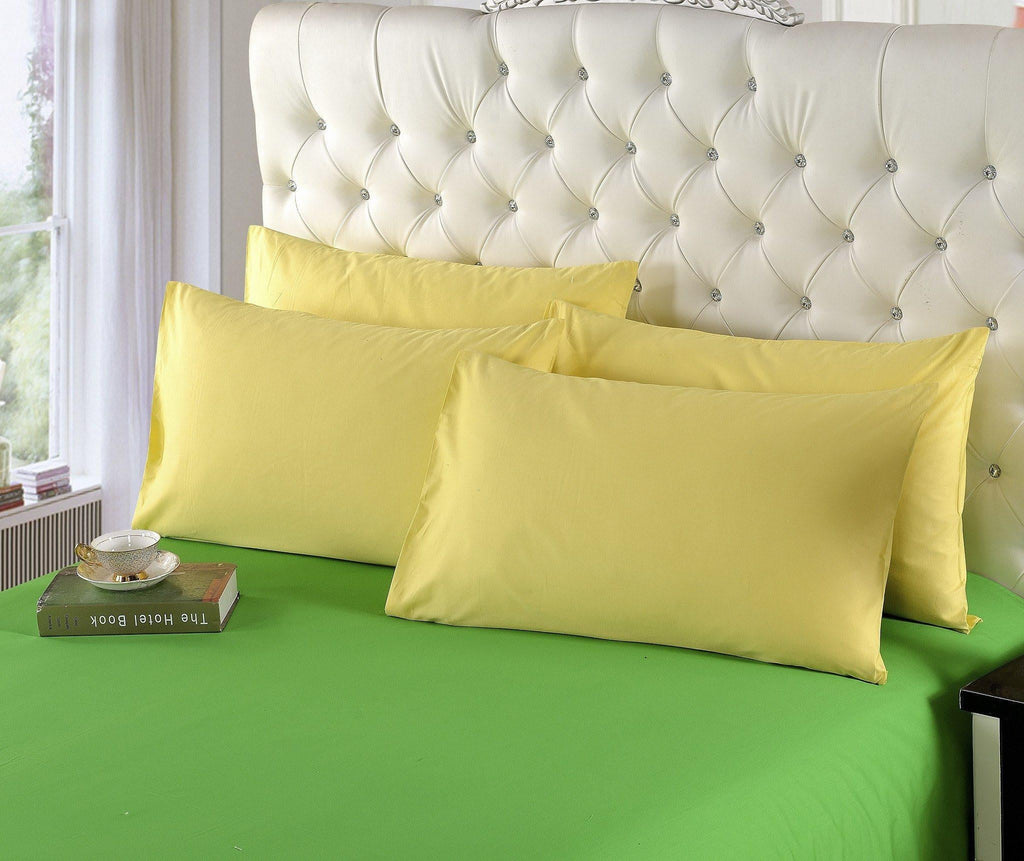 Banana yellow cotton duvet cover set with two matching pillow shams on bed