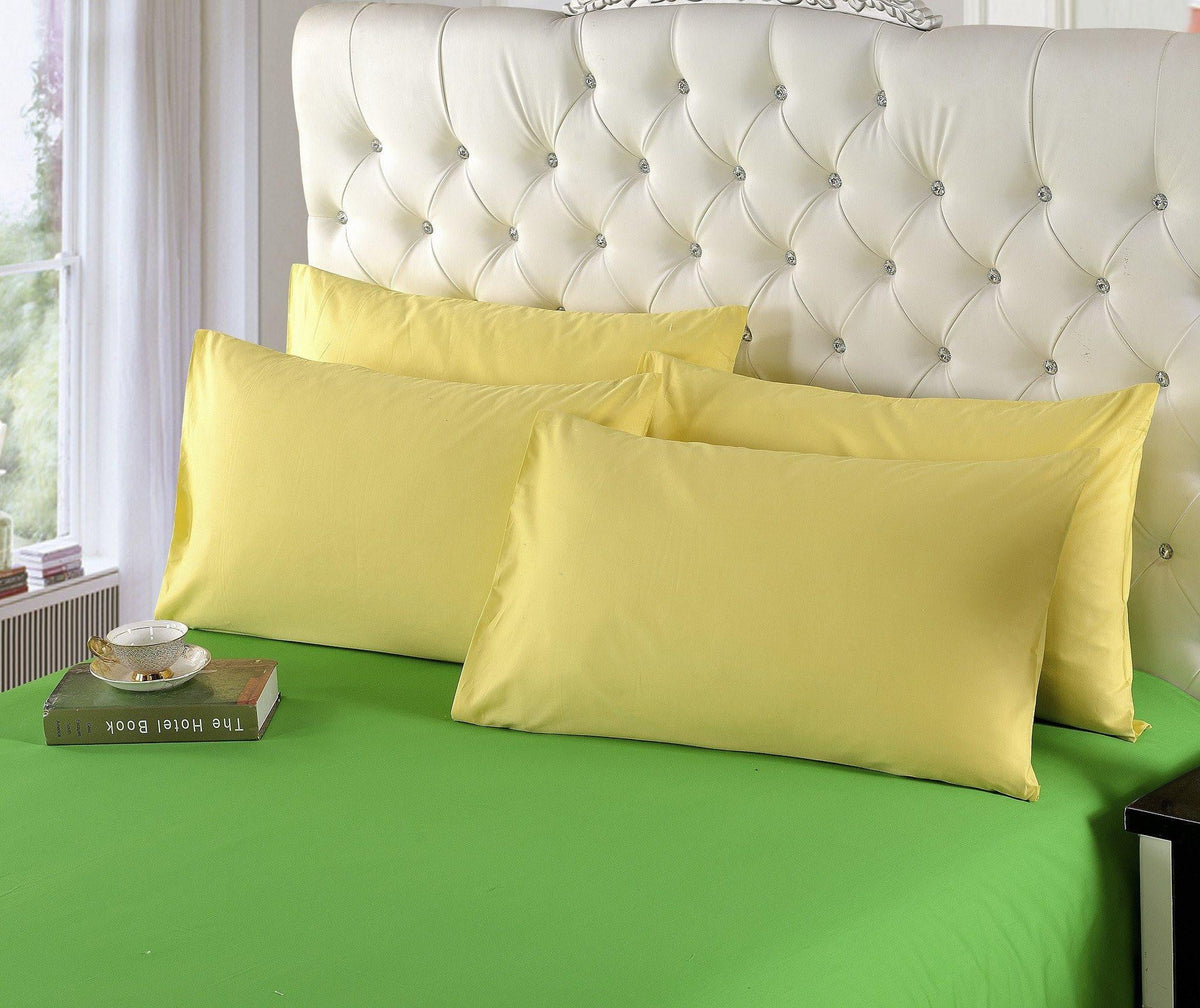 Banana yellow cotton duvet cover set with two matching pillow shams on bed