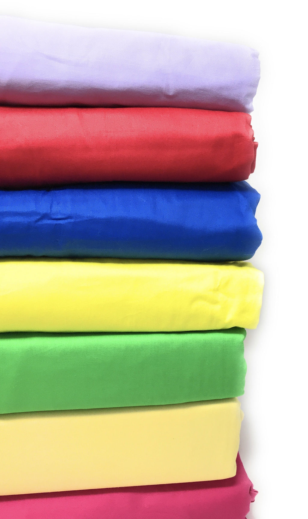 Color assortment of solid cotton bedding folds with banana yellow layer visible