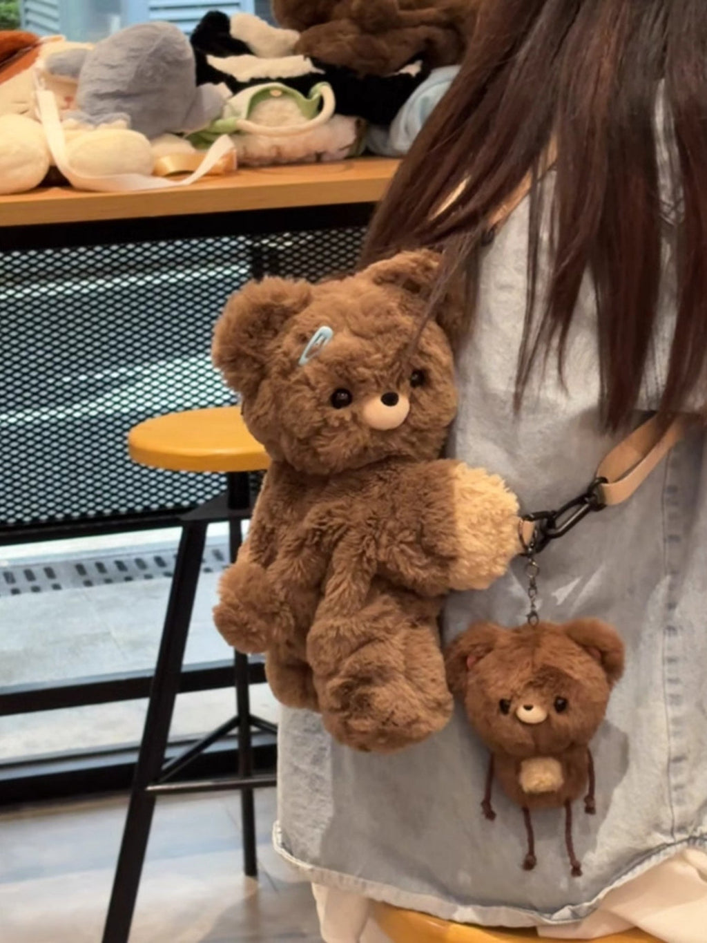 Brown plush teddy bear backpack bag with front teddy plush and small bear charm hanging