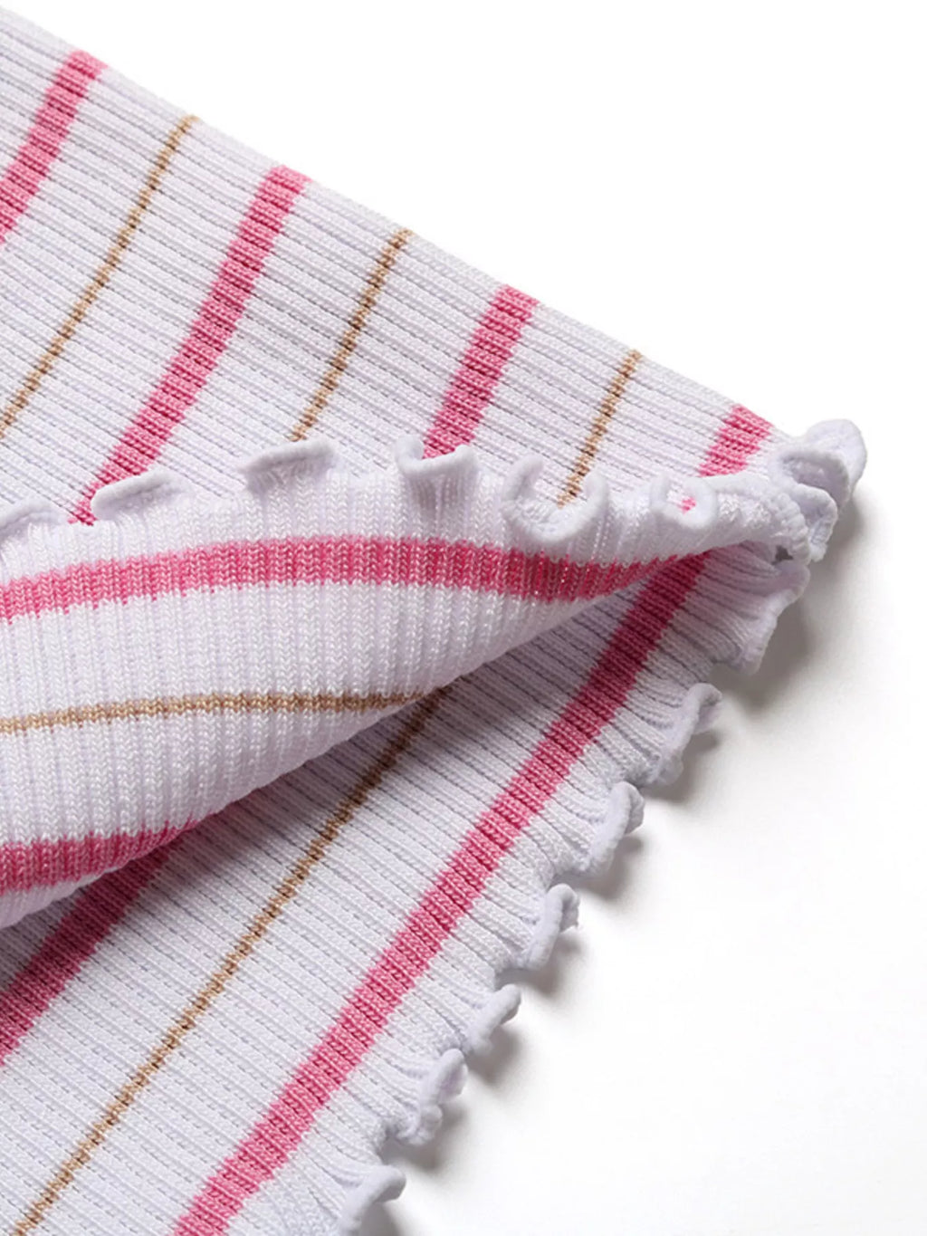 Close-up of striped knit hem with white scalloped ruffle and textured edge