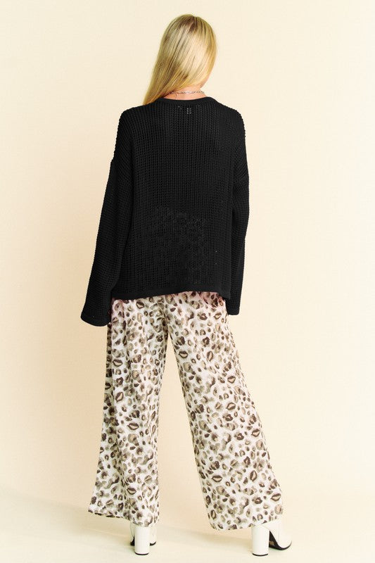 Black crochet knit sweater, back view with drop-shoulder sleeves and textured knit