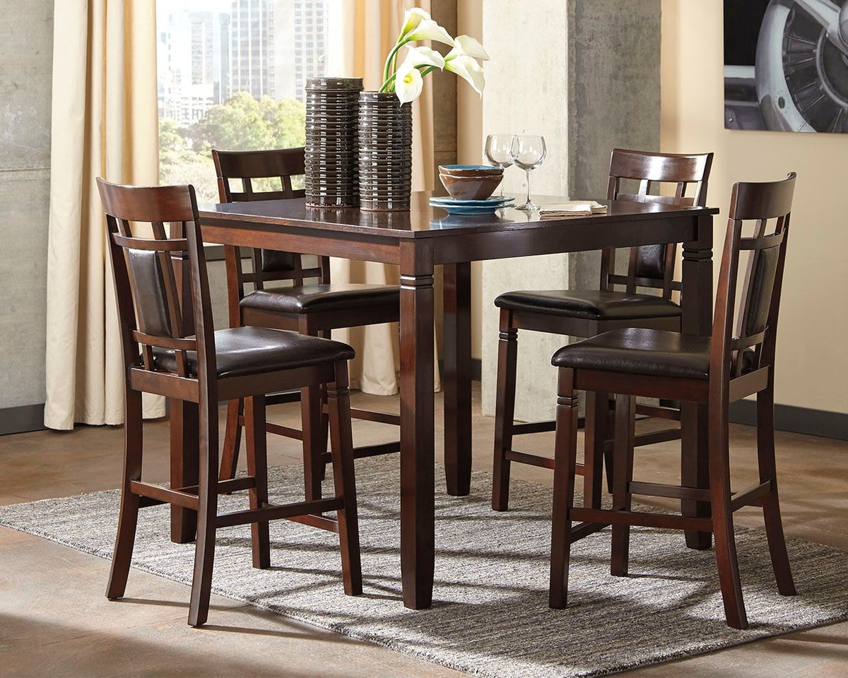 Rectangular brown counter table with four bar chairs and dark seat cushions