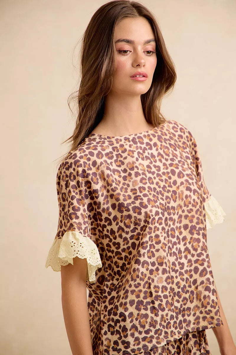 Leopard print ruffled top with lace-trim sleeves and eyelet lace cuff detail