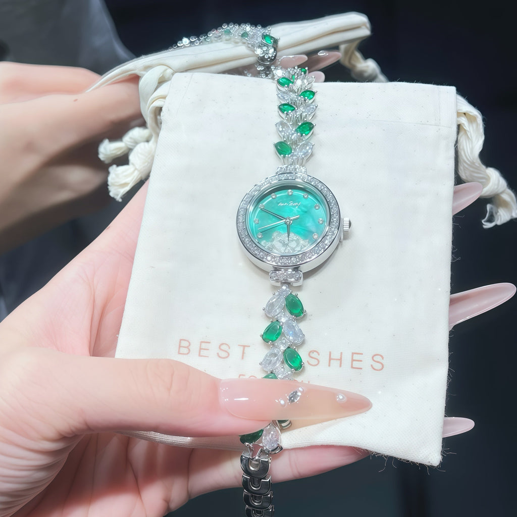 Teal dial wristwatch with green stones and silver rhinestone bracelet