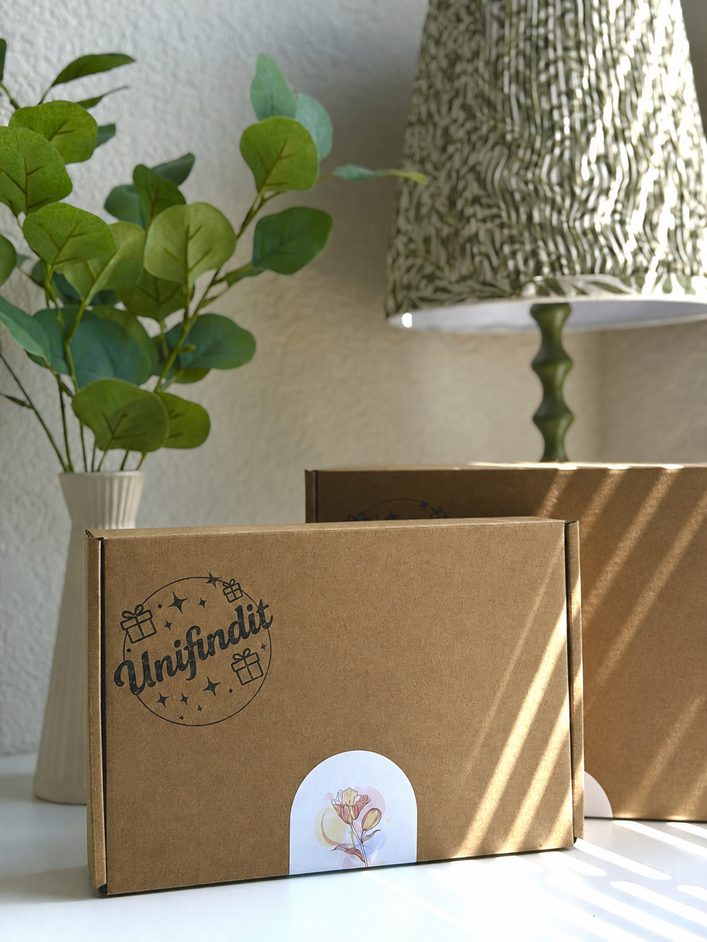 Brown gift box with circular cat illustration on front