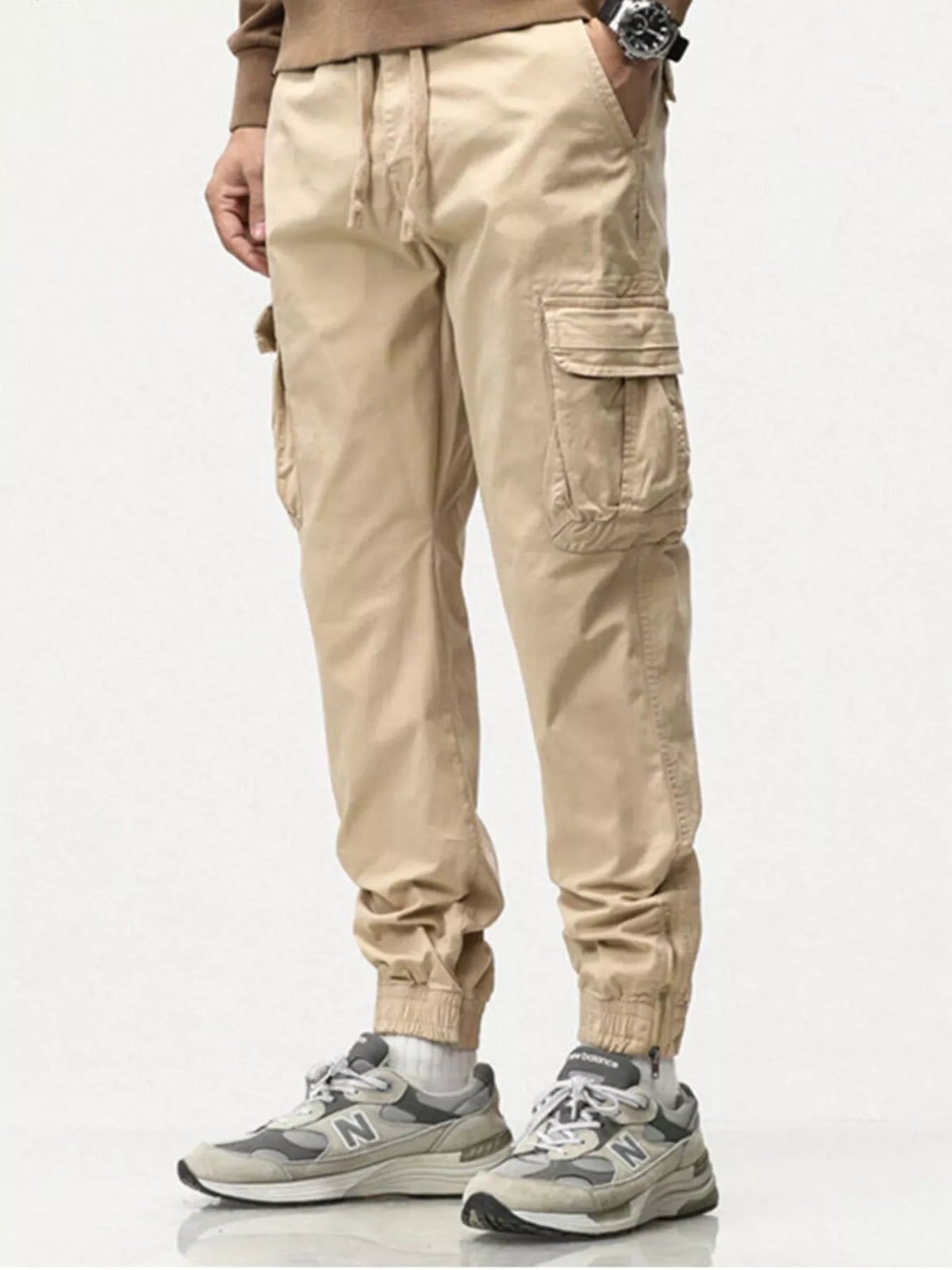 Men's casual cargo pants in light khaki with drawstring waist and cargo pocket detail