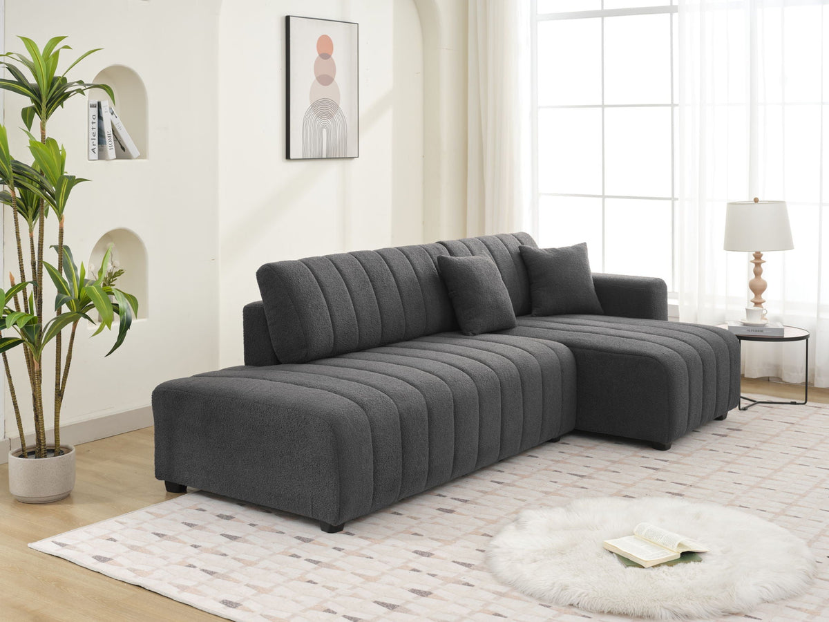 Dark gray sectional sofa with chaise and vertically tufted back cushions