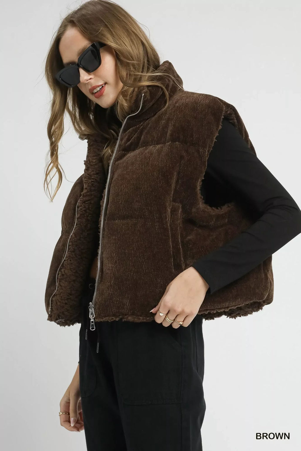 Brown sherpa-lined zip vest with drawstring hem, side profile with zip front