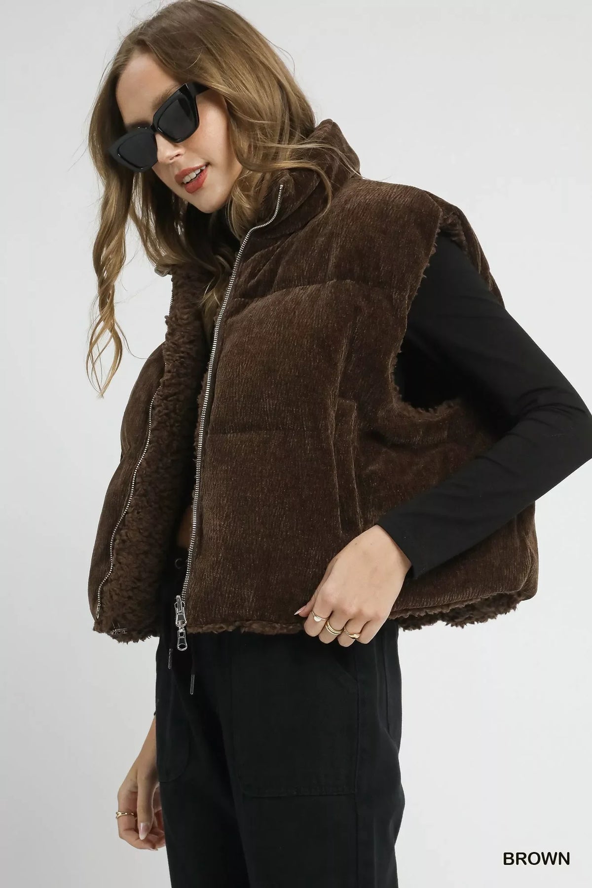 Brown sherpa-lined zip vest with drawstring hem, side profile with zip front