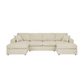 Beige sectional sofa with chaise lounge seats and tufted back cushions