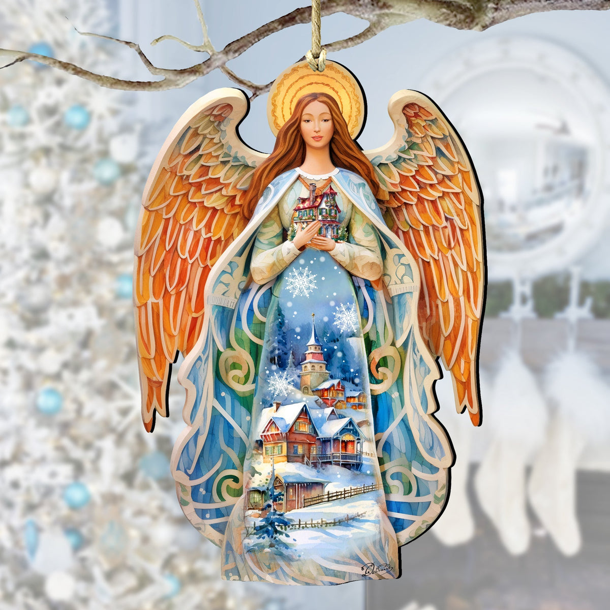 Wooden angel ornament with orange-gold wings and blue dress holding a nativity scene