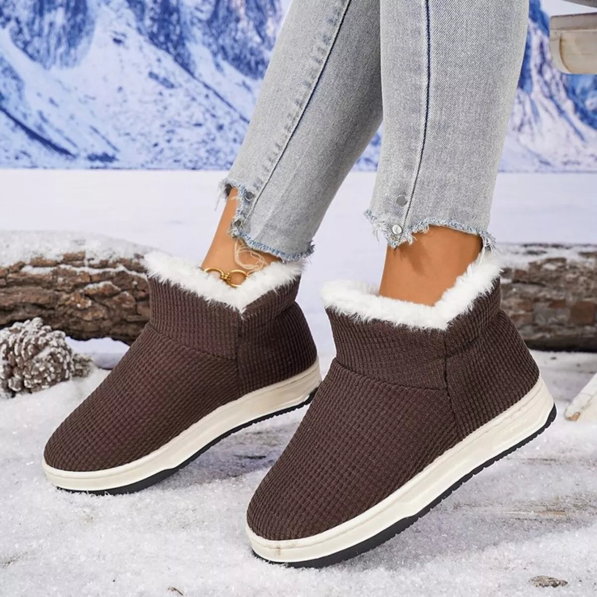 Chocolate brown knit ankle boots with fuzzy white trim and cream rubber sole