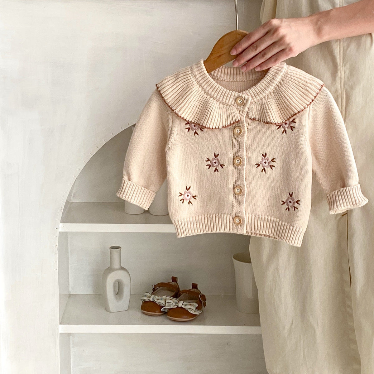 Stone powder knitted baby coat with Peter Pan collar, button-front and floral embroidery
