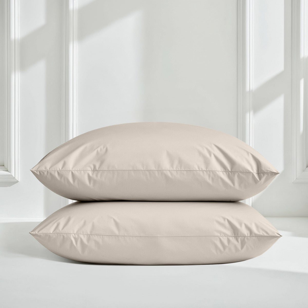 Sateen bedding set with stacked comforter and pillows in light beige/taupe color