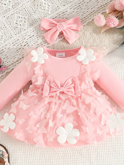 Pink dress with butterfly/flower appliques, layered ruffles, and matching bow headband