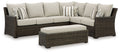 Sectional sofa set with brown wicker frame and light beige cushions, bench and ottoman