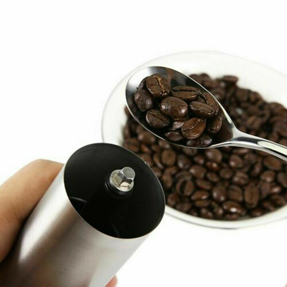Stainless steel manual coffee grinder with black top knob and grounds-catching bowl