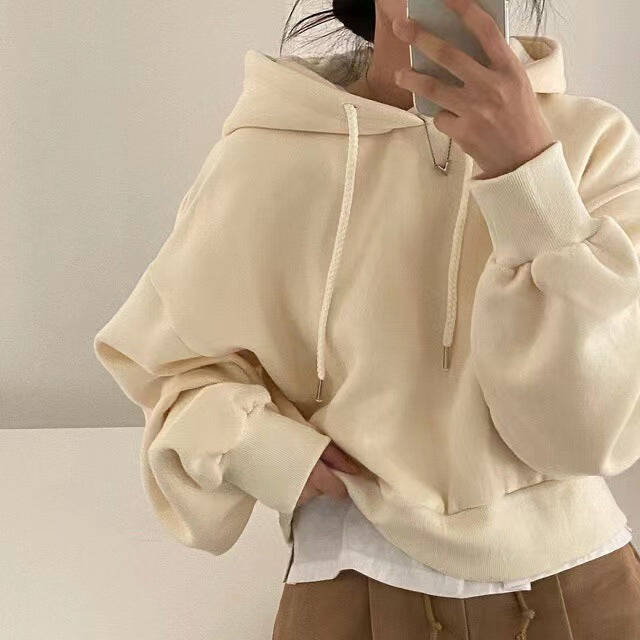 Women's hooded sweater, loose fit, cream pullover with hood, drawstrings, and kangaroo pocket