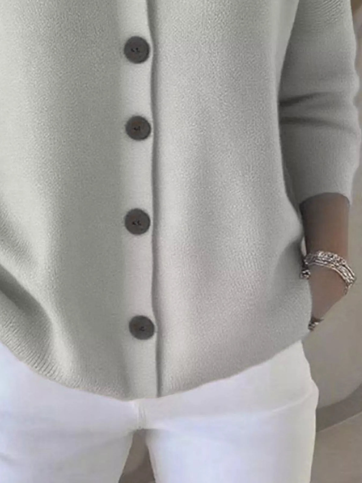 Light hooded button-front cardigan with long sleeves and dark round buttons